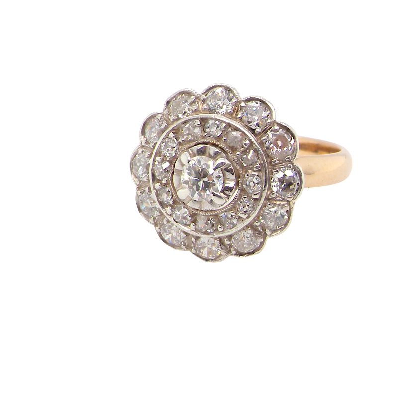 A beautiful vintage diamond cluster ring. Know as a target cluster, the diamonds are old brilliant cut. Centre diamond (0.20 carats) . 