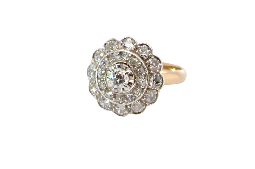 A beautiful vintage diamond cluster ring. Know as a target cluster, the diamonds are old brilliant cut. Centre diamond 3.8mm . 