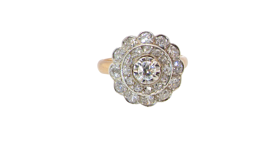 A beautiful vintage diamond cluster ring. Know as a target cluster, the diamonds are old brilliant cut. Centre diamond 3.8mm (0.20 carats) . 