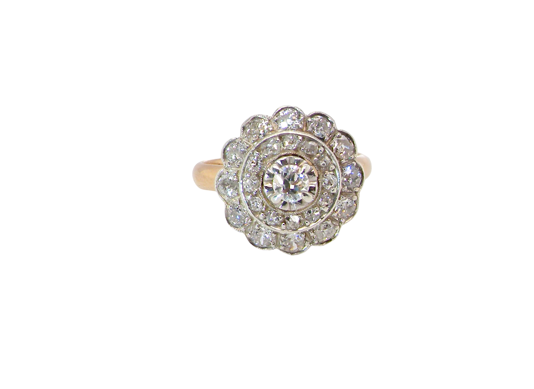 A beautiful vintage diamond cluster ring. Know as a target cluster, the diamonds are old brilliant cut. Centre diamond 3.8mm (0.20 carats) . 