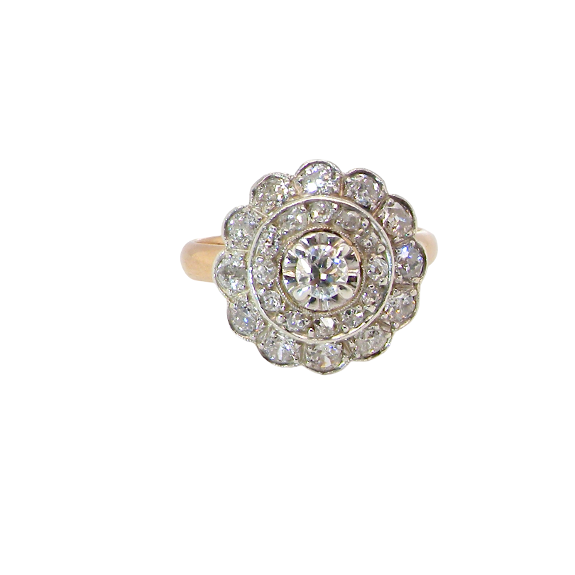 A beautiful vintage diamond cluster ring. Know as a target cluster, the diamonds are old brilliant cut. Centre diamond 3.8mm (0.20 carats) . 
