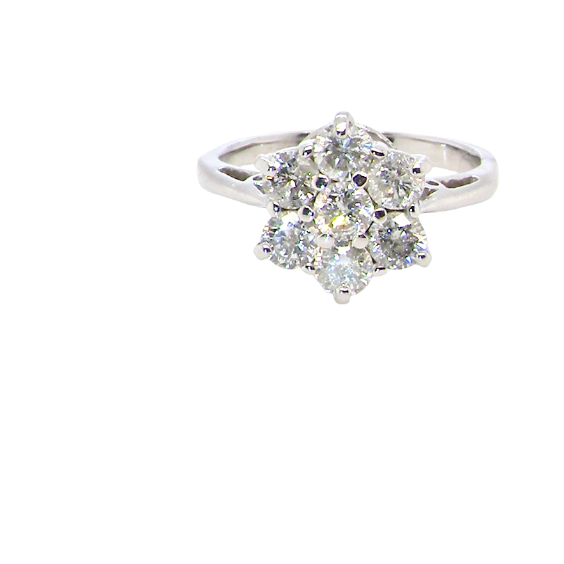 A beautiful vintage diamond cluster ring, elegantly set with seven brilliant-cut white diamonds in a timeless floral cluster design.