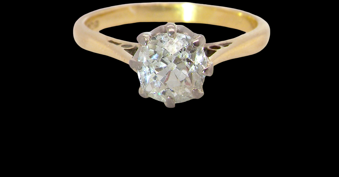 A beautiful vintage diamond solitaire ring featuring an old brilliant cut white diamond measuring approximately 6mm, estimated at 0.75 carats. The diamond displays attractive sparkle with an assessed colour