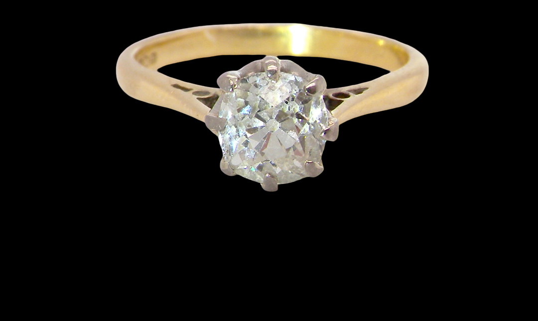 A beautiful vintage diamond solitaire ring featuring an old brilliant cut white diamond measuring approximately 6mm, estimated at 0.75 carats. The diamond displays attractive sparkle with an assessed colour