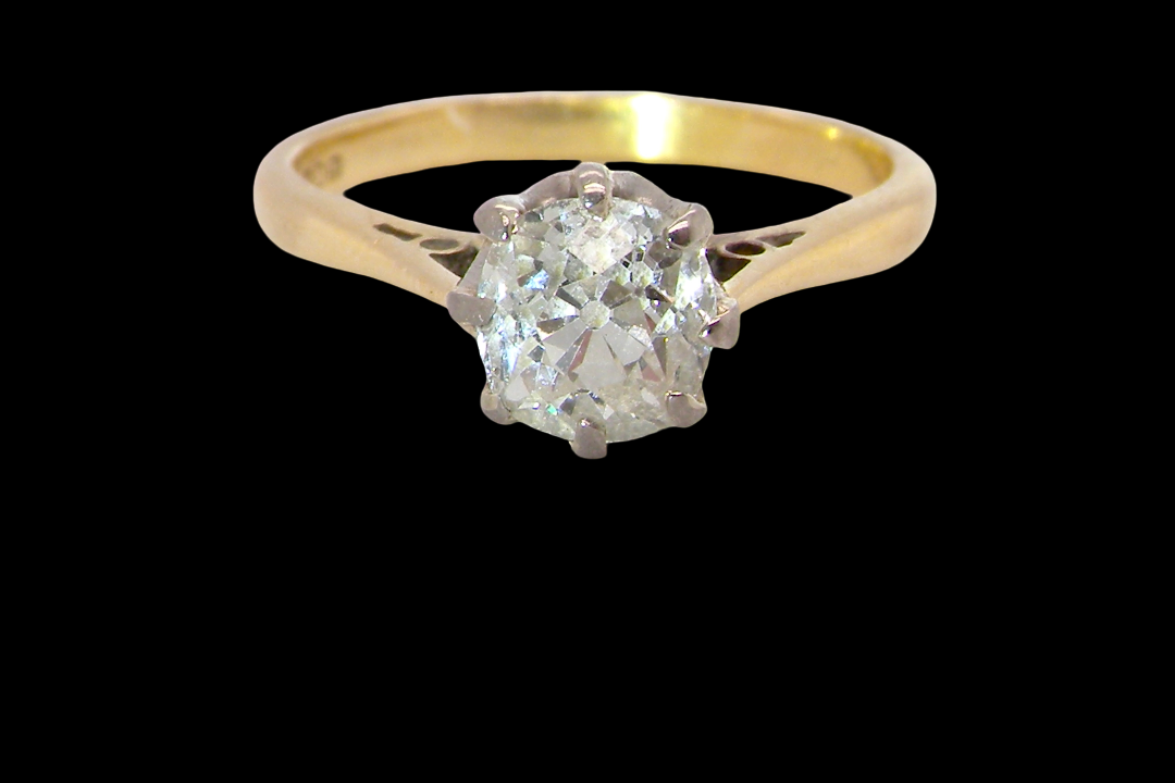 A beautiful vintage diamond solitaire ring featuring an old brilliant cut white diamond measuring approximately 6mm, estimated at 0.75 carats. The diamond displays attractive sparkle with an assessed colour