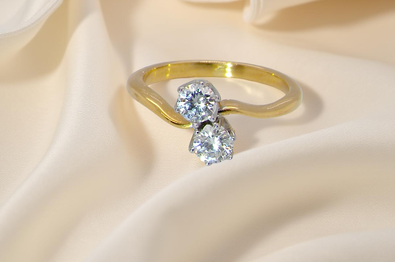 A beautifully balanced Moi et Toi ring featuring two modern brilliant-cut diamonds