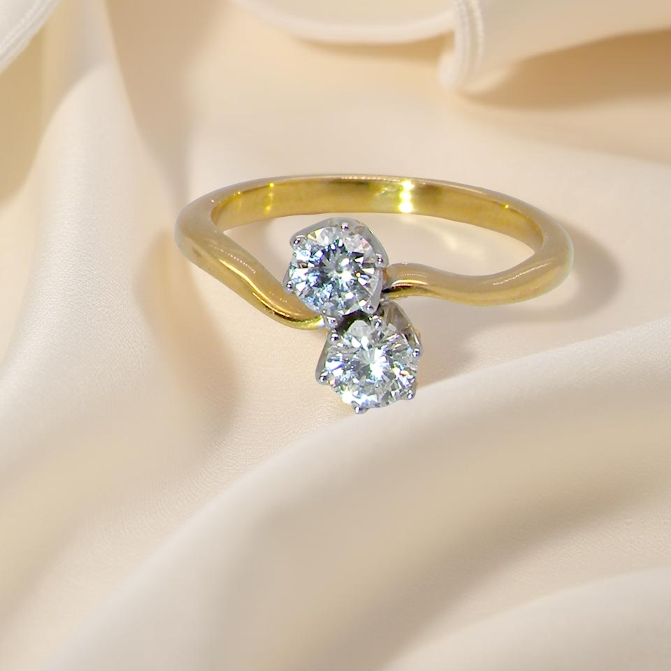 A beautifully balanced Moi et Toi ring featuring two modern brilliant-cut diamonds
