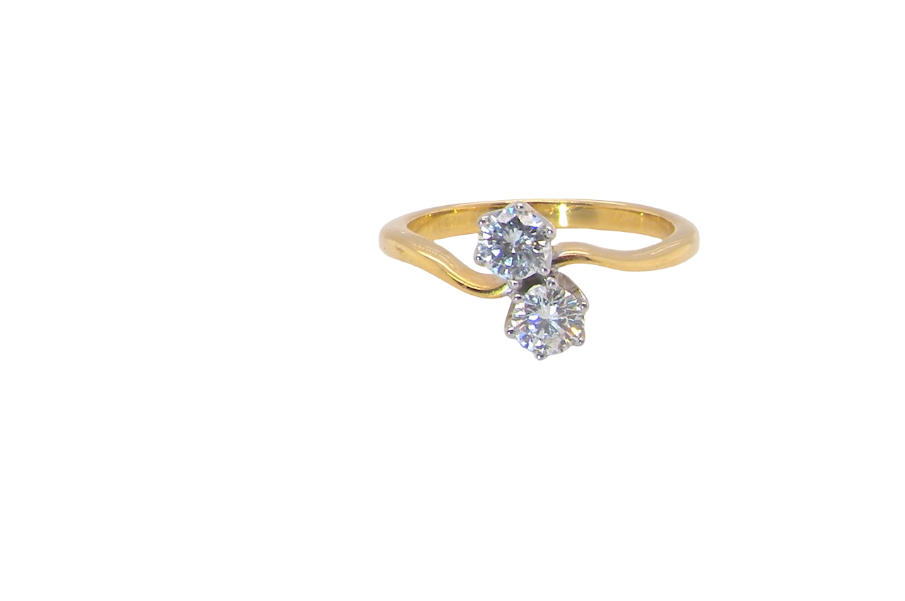 A beautifully balanced Moi et Toi ring featuring two sparkling modern brilliant-cut diamonds