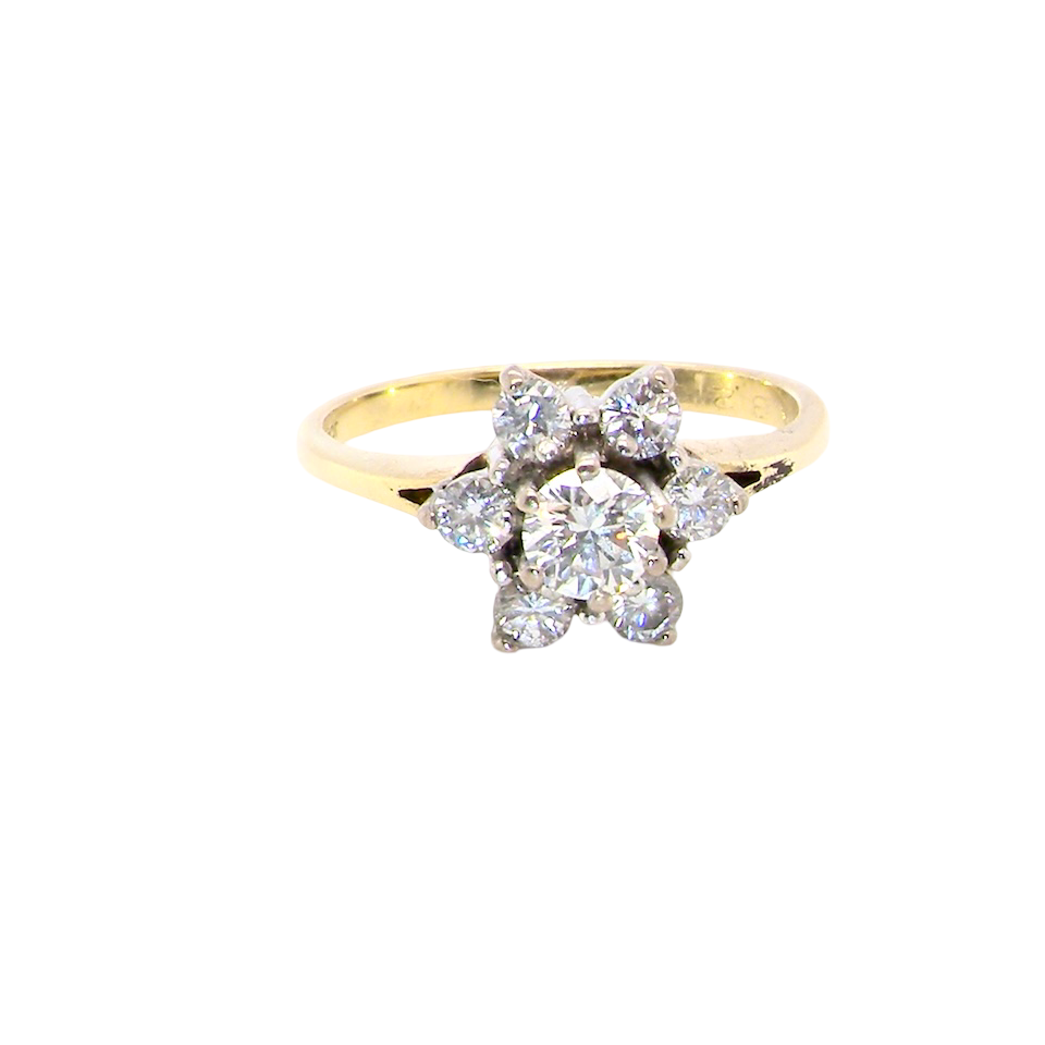 A beautifully crafted vintage diamond cluster ring, dating to the 1960s, featuring a classic floral-inspired design that remains timeless and elegant.