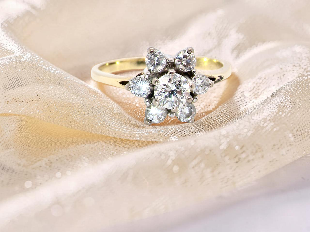 A beautifully crafted vintage diamond cluster ring, dating to the 1960s, featuring a classic design that remains timeless and elegant.