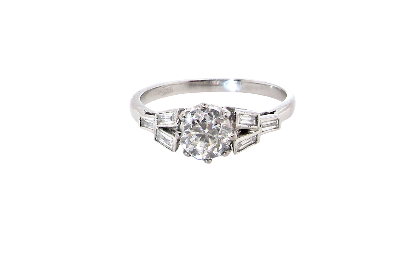 A beautifully proportioned Art Deco solitaire ring showcasing a sparkling old brilliant cut white diamond