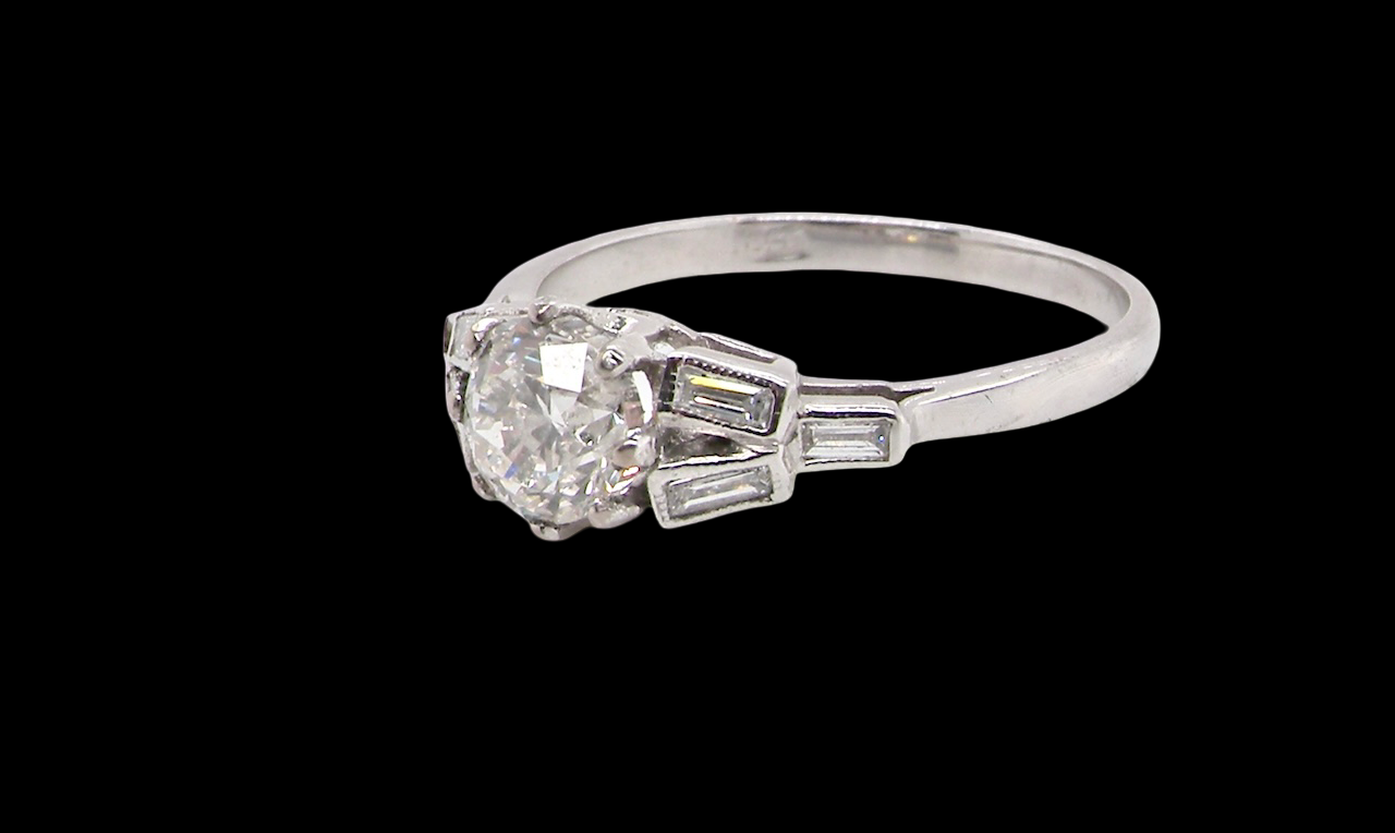 A beautifully proportioned Art Deco solitaire ring showcasing a sparkling old brilliant cut white diamond side