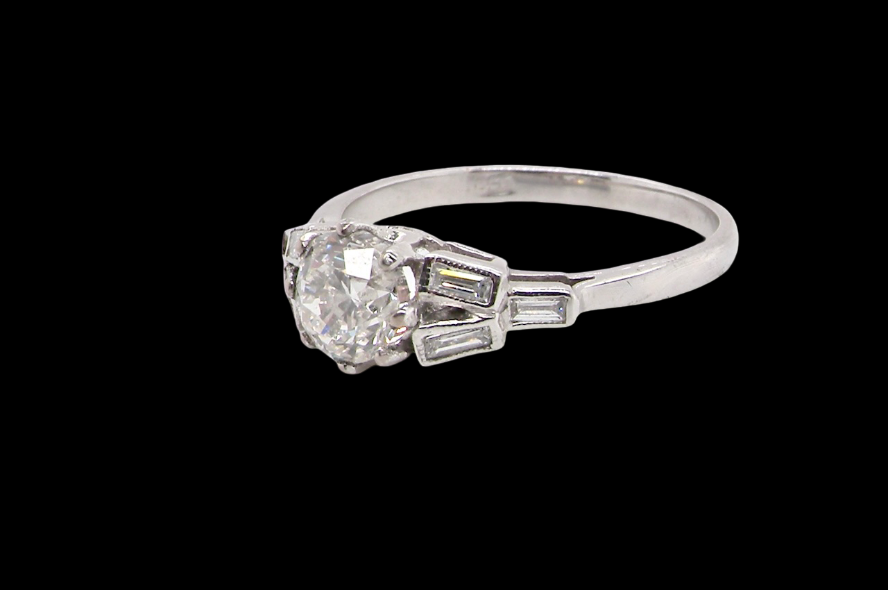 A beautifully proportioned Art Deco solitaire ring showcasing a sparkling old brilliant cut white diamond side