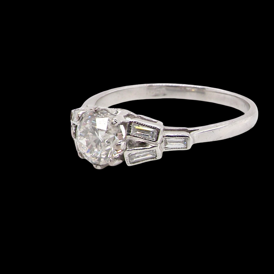 A beautifully proportioned Art Deco solitaire ring showcasing a sparkling old brilliant cut white diamond side