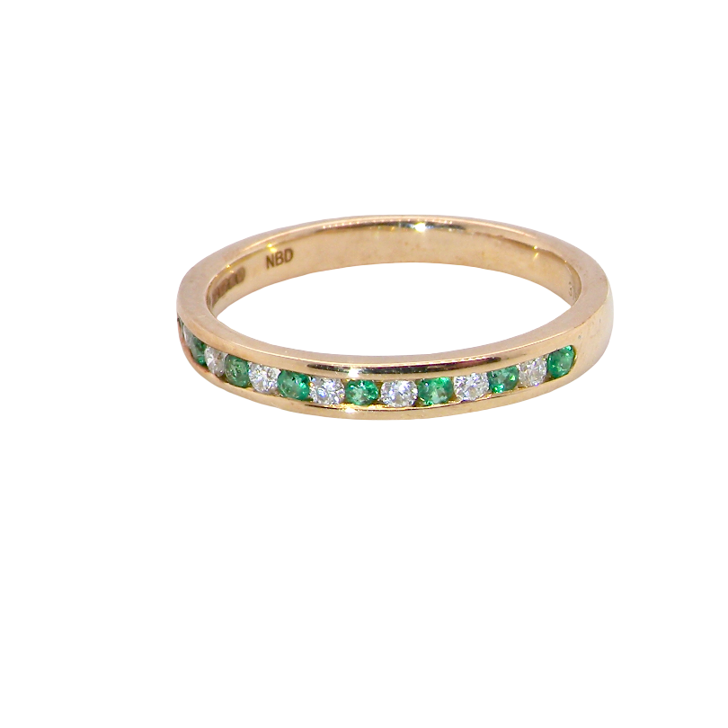 A brand new half hoop eternity ring. Set with eight 1.3mm emeralds (total 0.12 carats) and interspaced with brilliant cut white diamonds, each 1.3mm (0.10 carats)