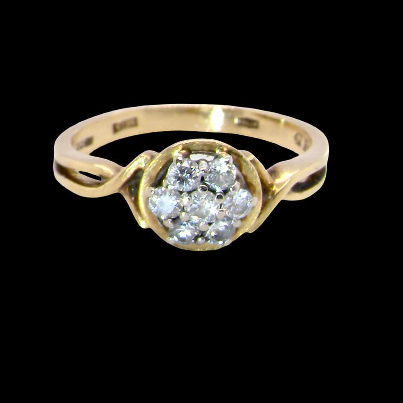 A classic 1980s cluster ring. Seven brilliant cut white diamonds , each 2.5mm (est 0.40 carats). Colour i-j, clarity Si.
