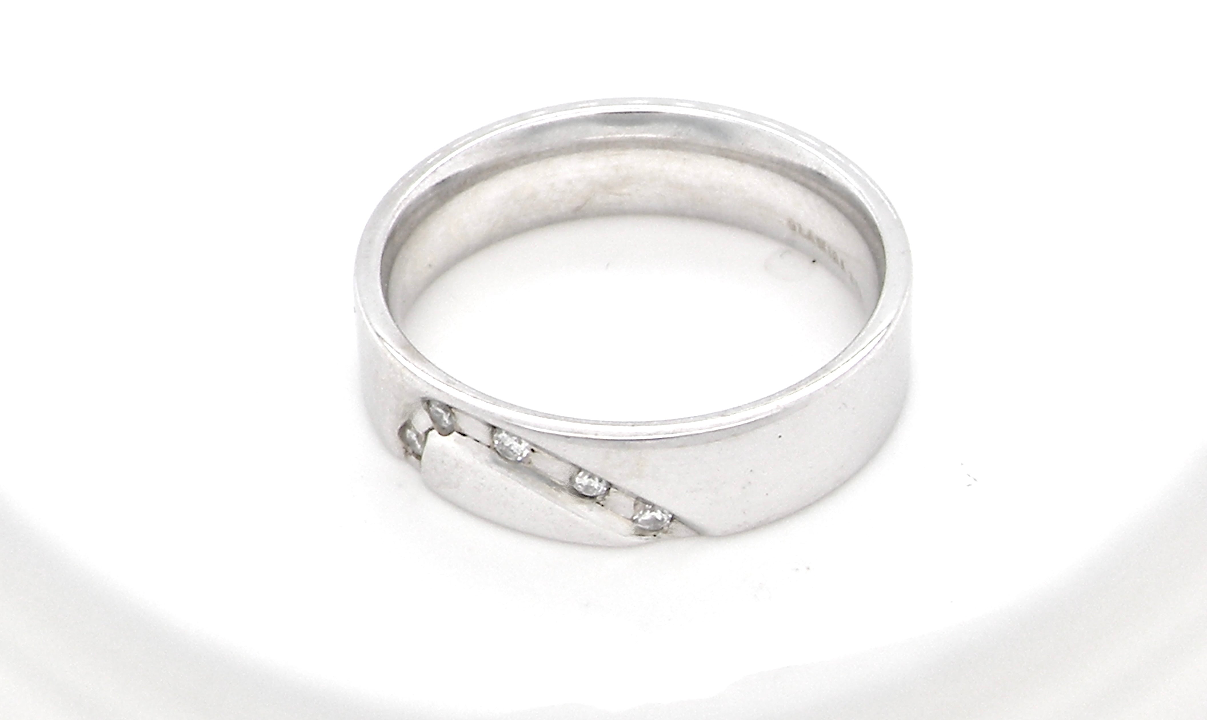 A classic 9 carat white gold ring with a timeless wedding-band style, equally suited to wear as a simple diamond dress ring.