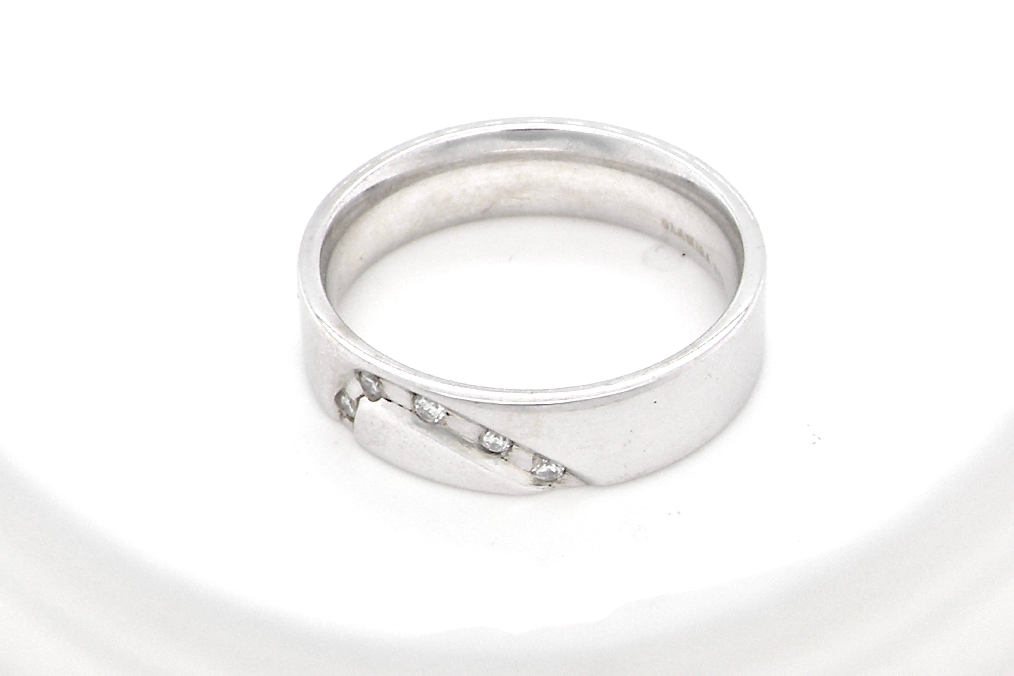 A classic 9 carat white gold ring with a timeless wedding-band style, equally suited to wear as a simple diamond dress ring.