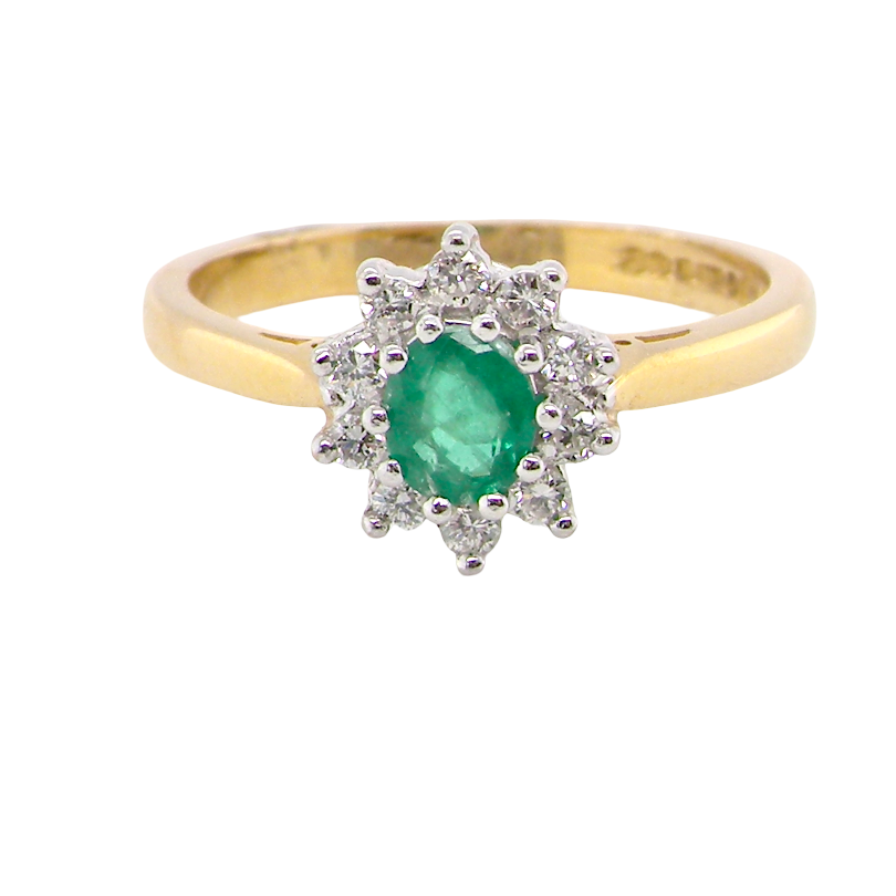 A classic cluster ring. Features to the centre a round emerald, comlimented by brilliant cut white diamonds