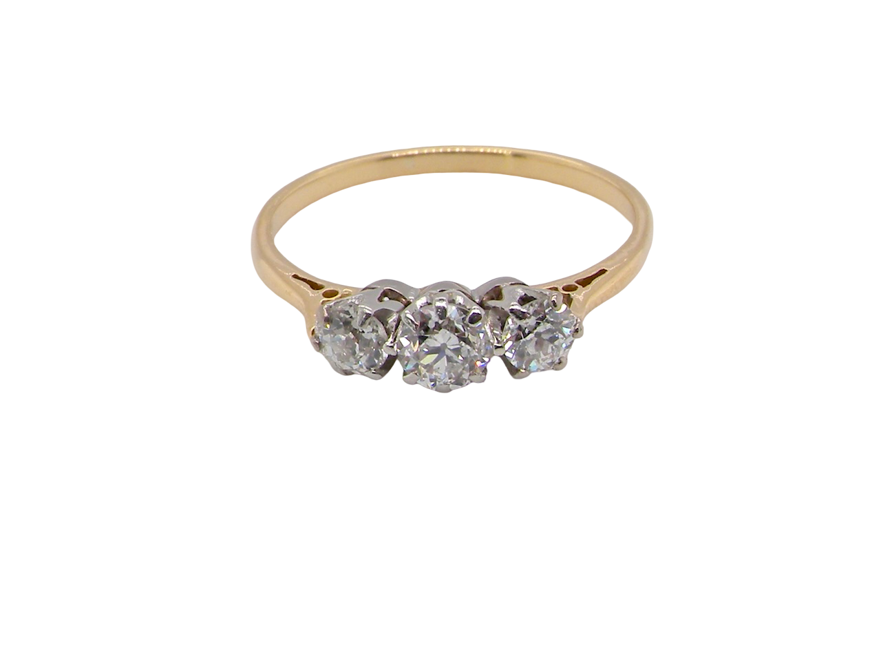 Gold ring with three diamonds on a white background
