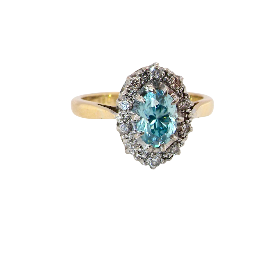 A cluster ring set with a natural blue zircon centre stone, 7.5x5mm, aquamarine colour. 