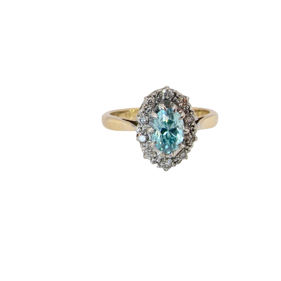 A cluster ring set with a natural blue zircon centre stone, 7.5x5mm, vibrant aquamarine colour. 