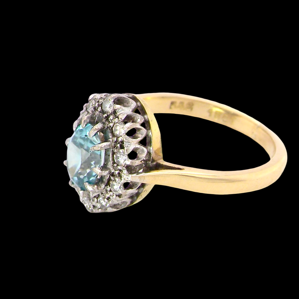 A cluster ring set with a natural blue zircon centre stone, 7.5x5mm, vibrant aquamarine colour.
side