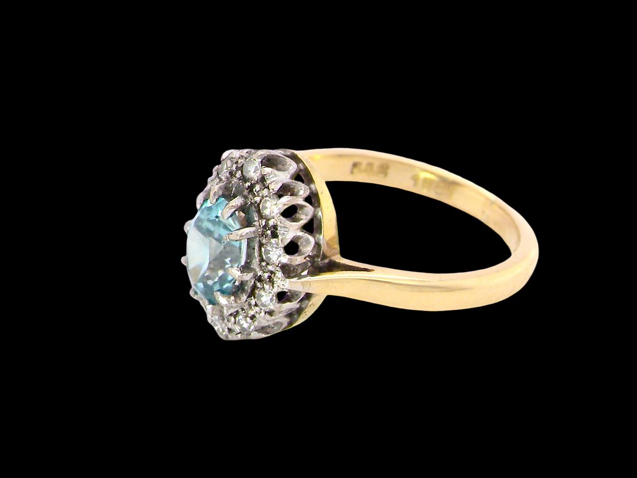 A cluster ring set with a natural blue zircon centre stone, 7.5x5mm, vibrant aquamarine colour.
side
