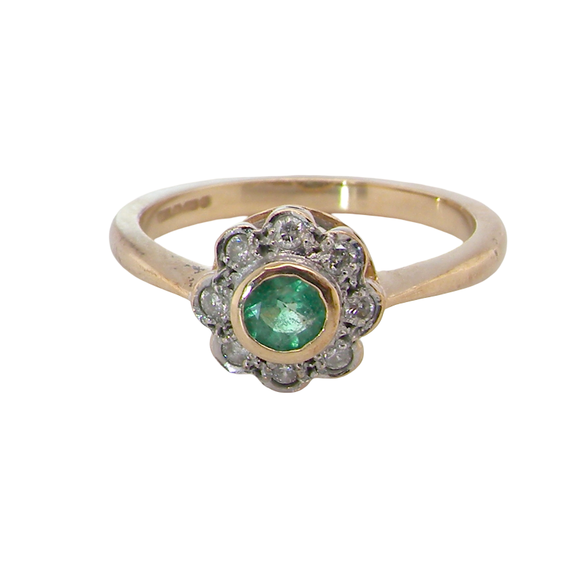 A vintage-style gold ring featuring a central round green emerald-cut gemstone surrounded by a halo of small clear stones, set on a plain white background.