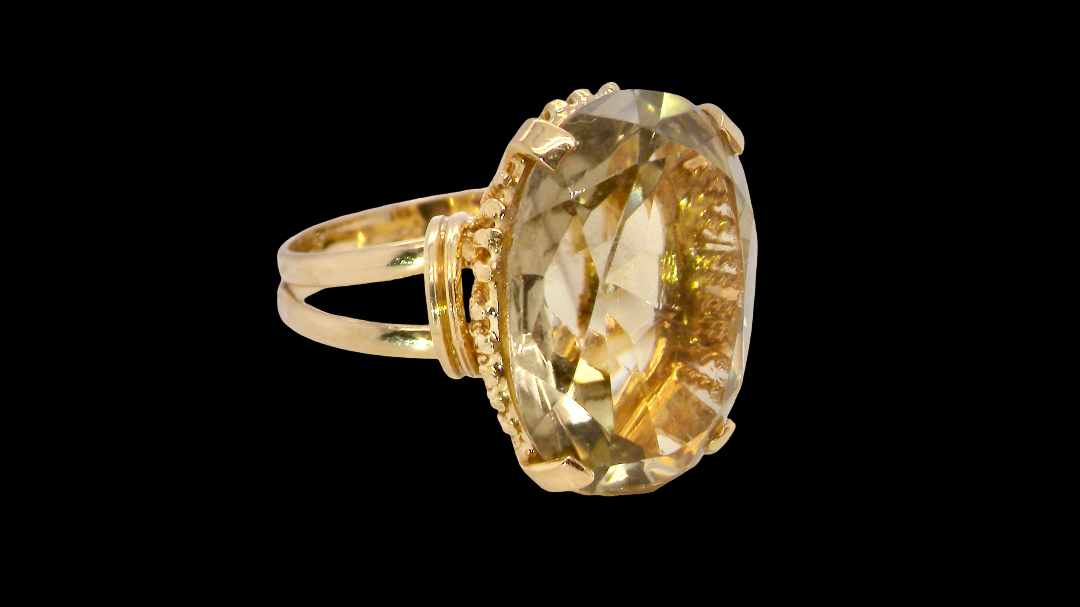 A continental dress ring that tests as 18 carat gold. Features a large citrine gemstone, that measures 18x13mm, depth 9mm. Golden with a hint of olive green. 