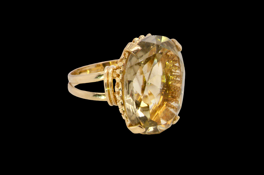 A continental dress ring that tests as 18 carat gold. Features a large citrine gemstone, that measures 18x13mm, depth 9mm. Golden with a hint of olive green. 
