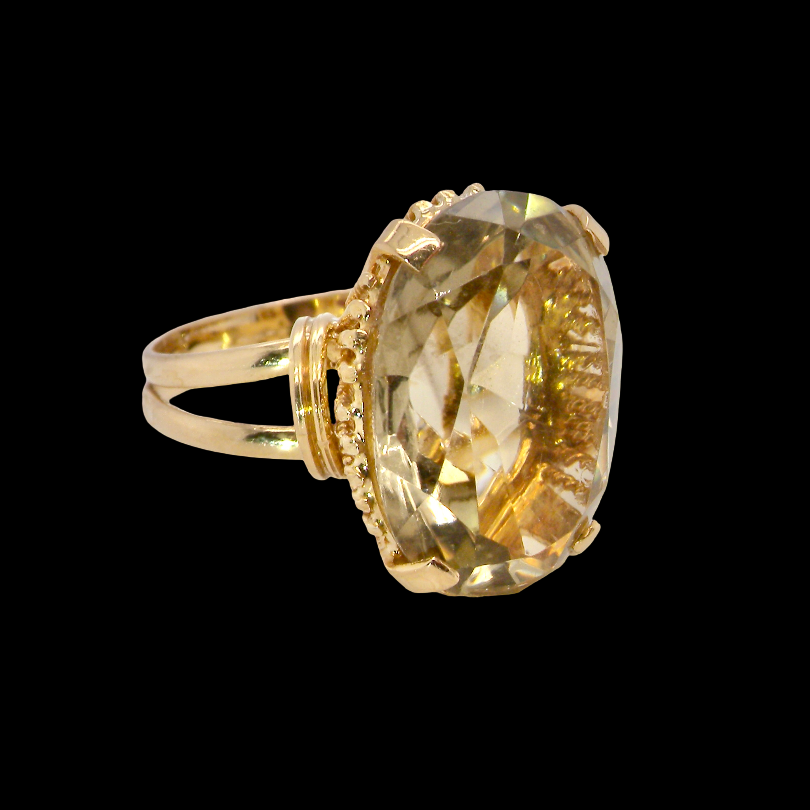 A continental dress ring that tests as 18 carat gold. Features a large citrine gemstone, that measures 18x13mm, depth 9mm. Golden with a hint of olive green. 