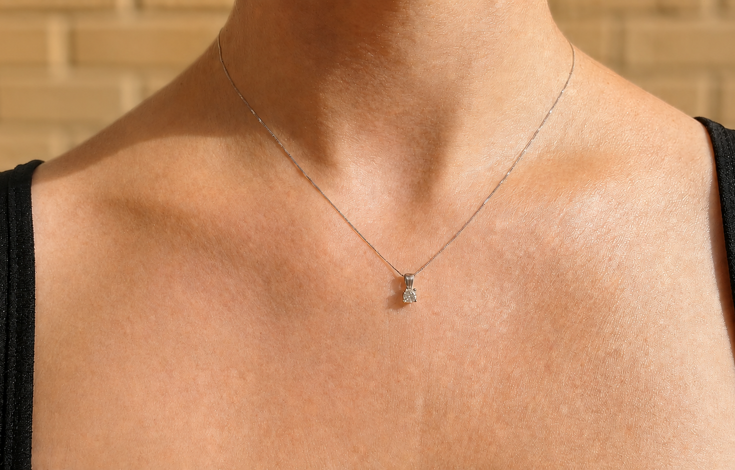 A diamond pendant on a female neck