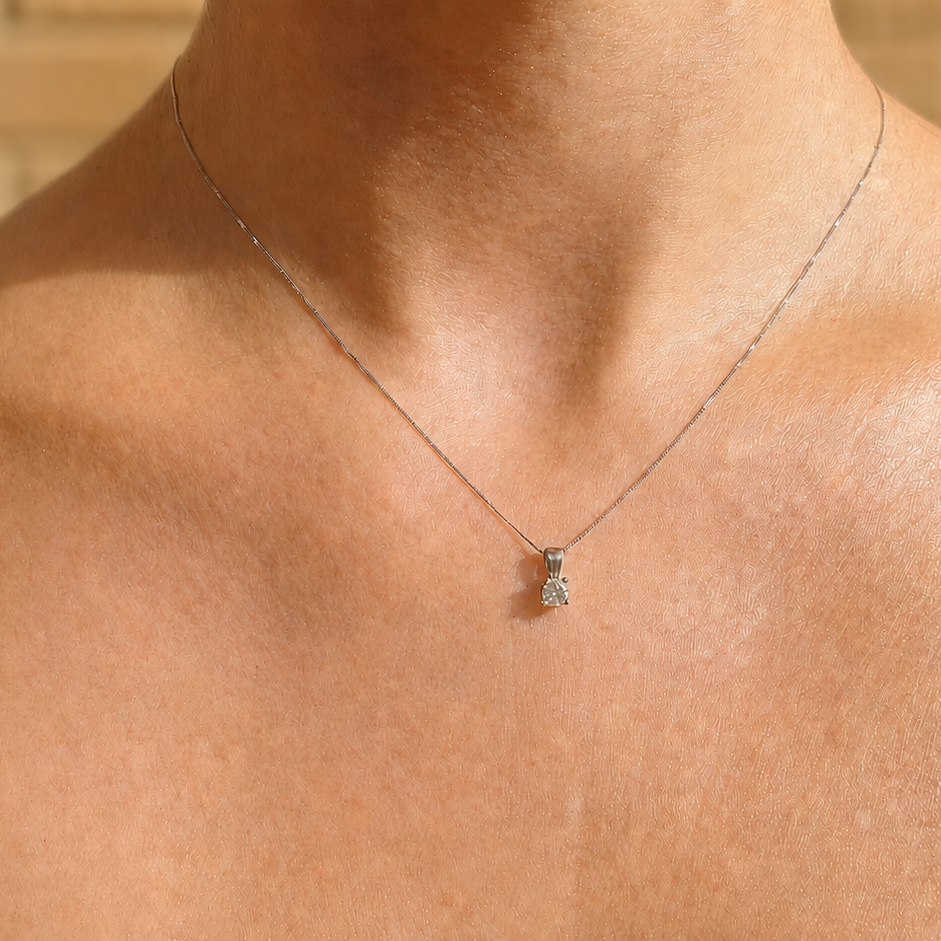 A diamond pendant on a female neck