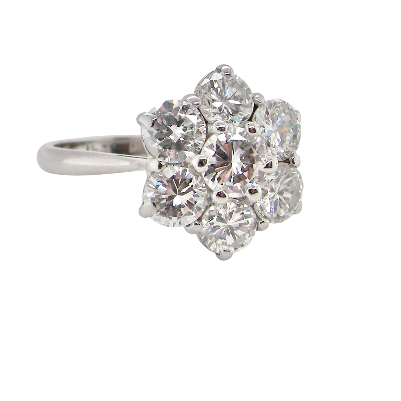 A fabulous vintage diamond cluster ring, beautifully crafted in 18 carat white gold and set with 7 fine brilliant cut white diamonds.