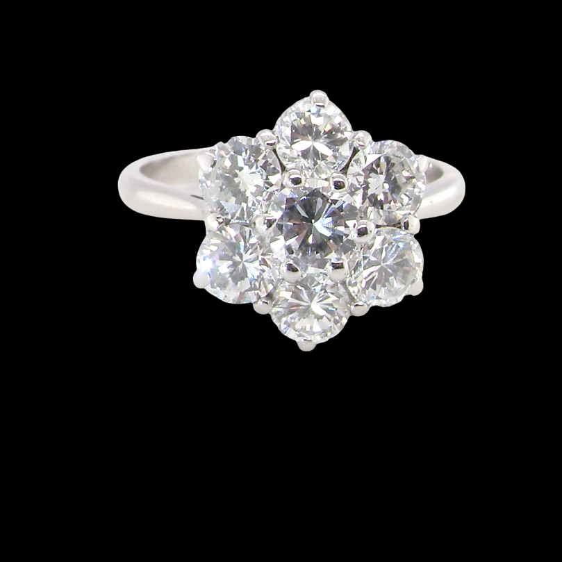A fabulous vintage diamond cluster ring, beautifully crafted in 18 carat white gold and set with seven brilliant cut white diamonds.