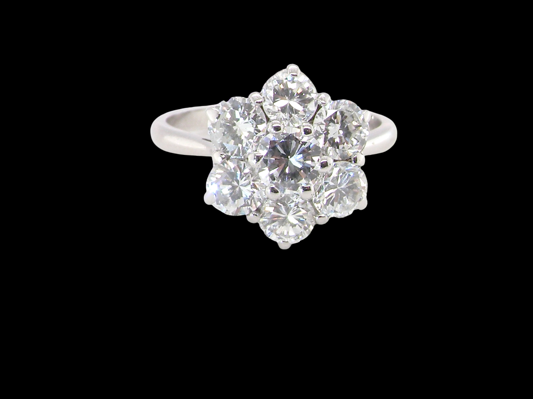 A fabulous vintage diamond cluster ring, beautifully crafted in 18 carat white gold and set with seven brilliant cut white diamonds.