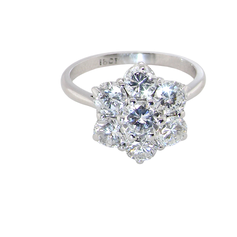 A fabulous vintage diamond cluster ring, beautifully crafted in 18 carat white gold and set with seven fine brilliant cut diamonds.