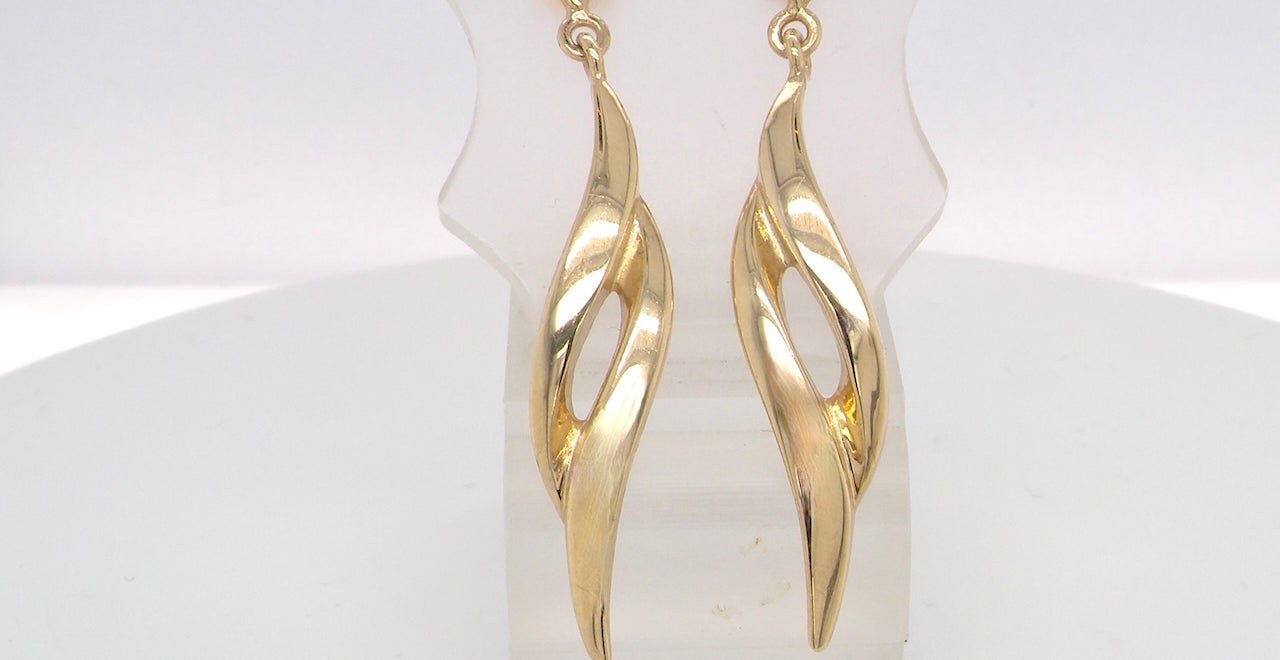 A feature pair of long drop earrings. Each a double loop that has a length of 38mm, width 8mm. Flame shaped top to the post and scroll.