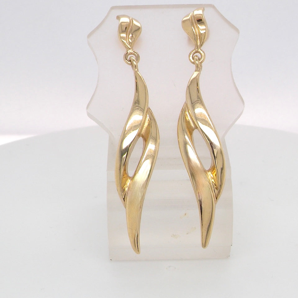 A feature pair of long drop earrings. Each a double loop that has a length of 38mm, width 8mm. Flame shaped top to the post and scroll.
