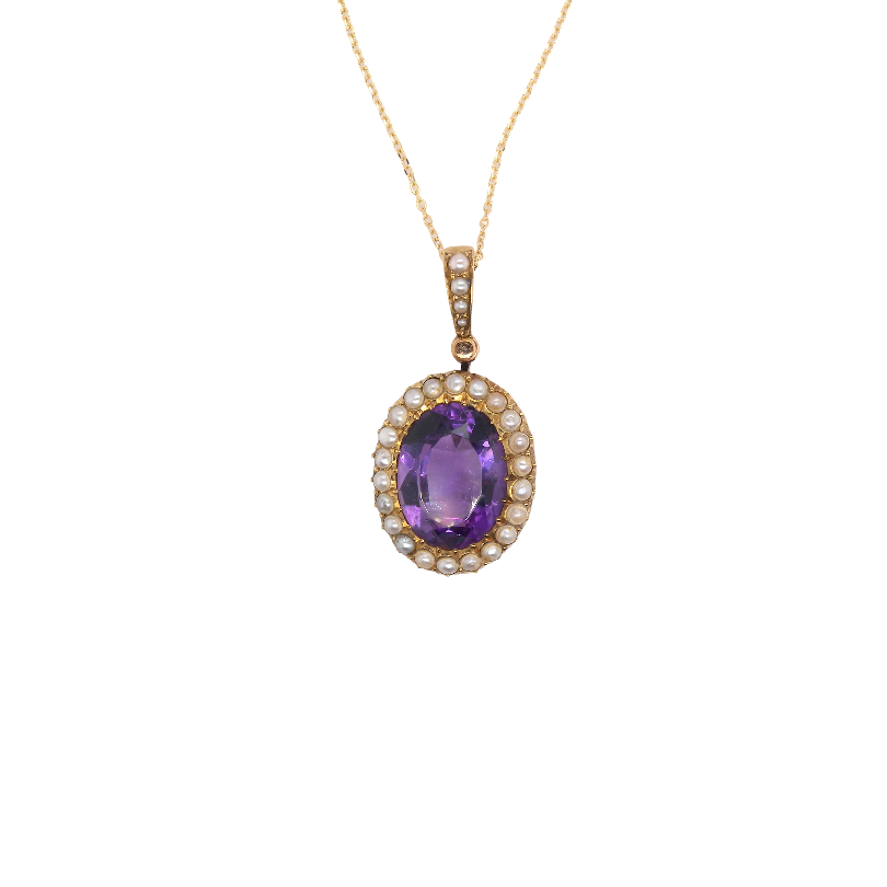 An oval pendant necklace featuring a central purple amethyst gemstone surrounded by a halo of small clear stones, set in yellow gold and suspended from a delicate gold chain against a plain white background.