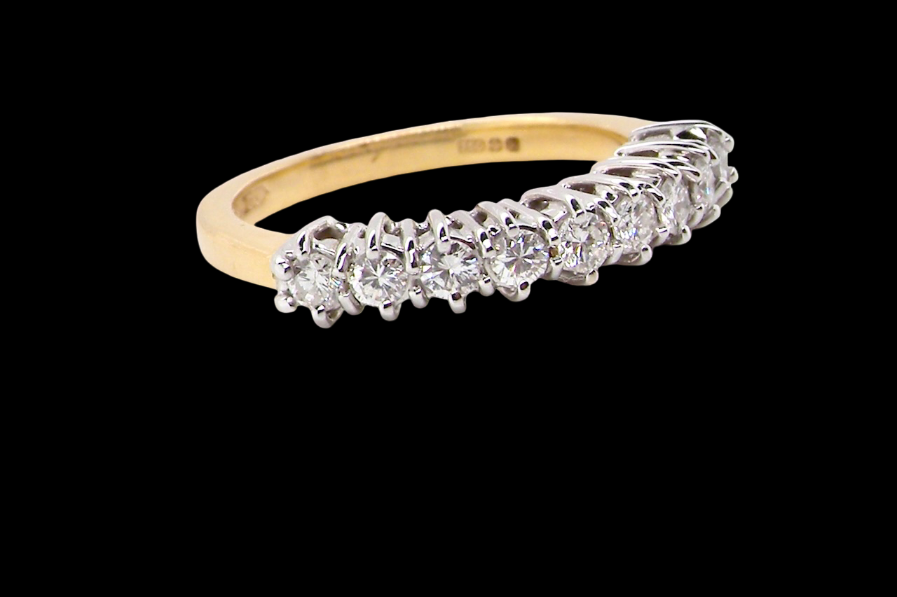 A fine 18 carat gold half hoop eternity ring, beautifully set with an array of brilliant-cut white diamonds.
