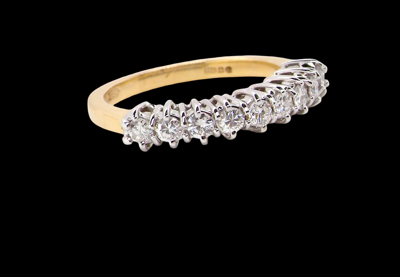 A fine 18 carat gold half hoop eternity ring, beautifully set with an array of brilliant-cut white diamonds.
