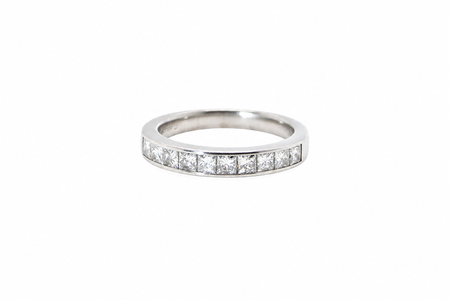 A fine 18 carat white gold half hoop eternity ring. Set with ten princess cut white diamonds.
Close set, each 2.5x2.5mm, total one carat
