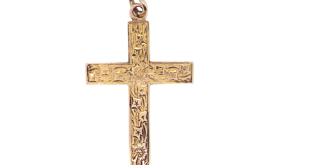 A fine 9 carat gold cross. Hand engrarved across the whole body of the cross which measures 45x25mm