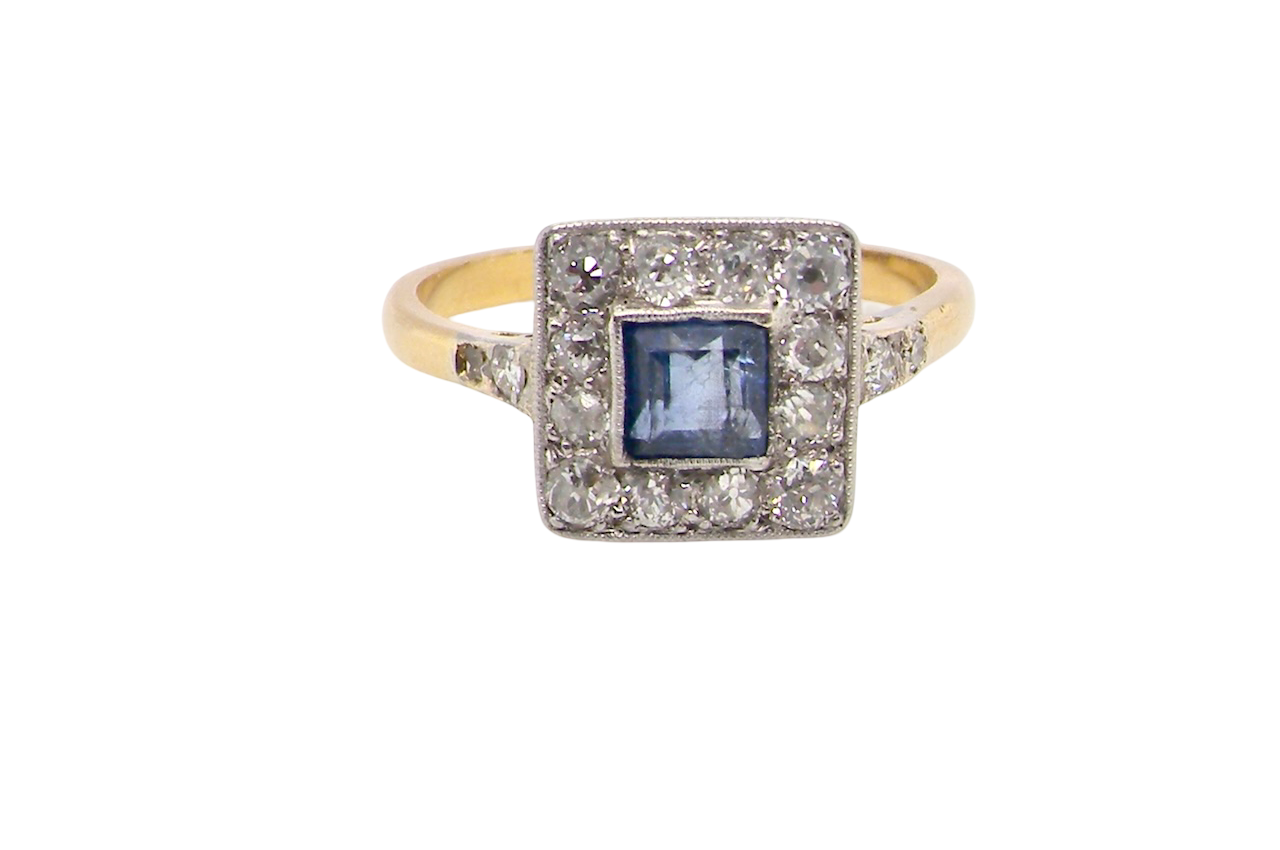 A fine Art Deco cluster ring. The centre stone a square sapphire 5x5mm (est 0.50 carats) in a mille grain setting.