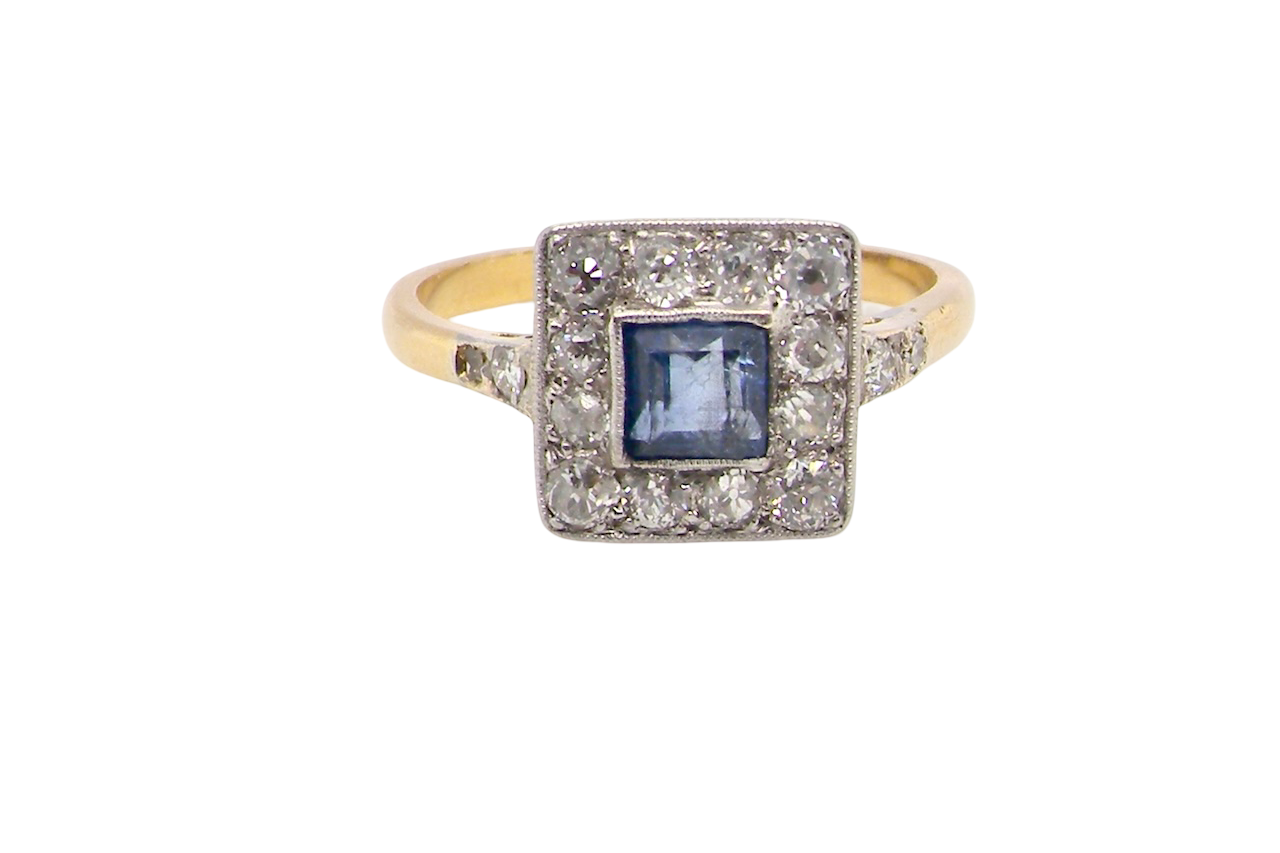 A fine Art Deco cluster ring. The centre stone a square sapphire 5x5mm (est 0.50 carats) in a mille grain setting.