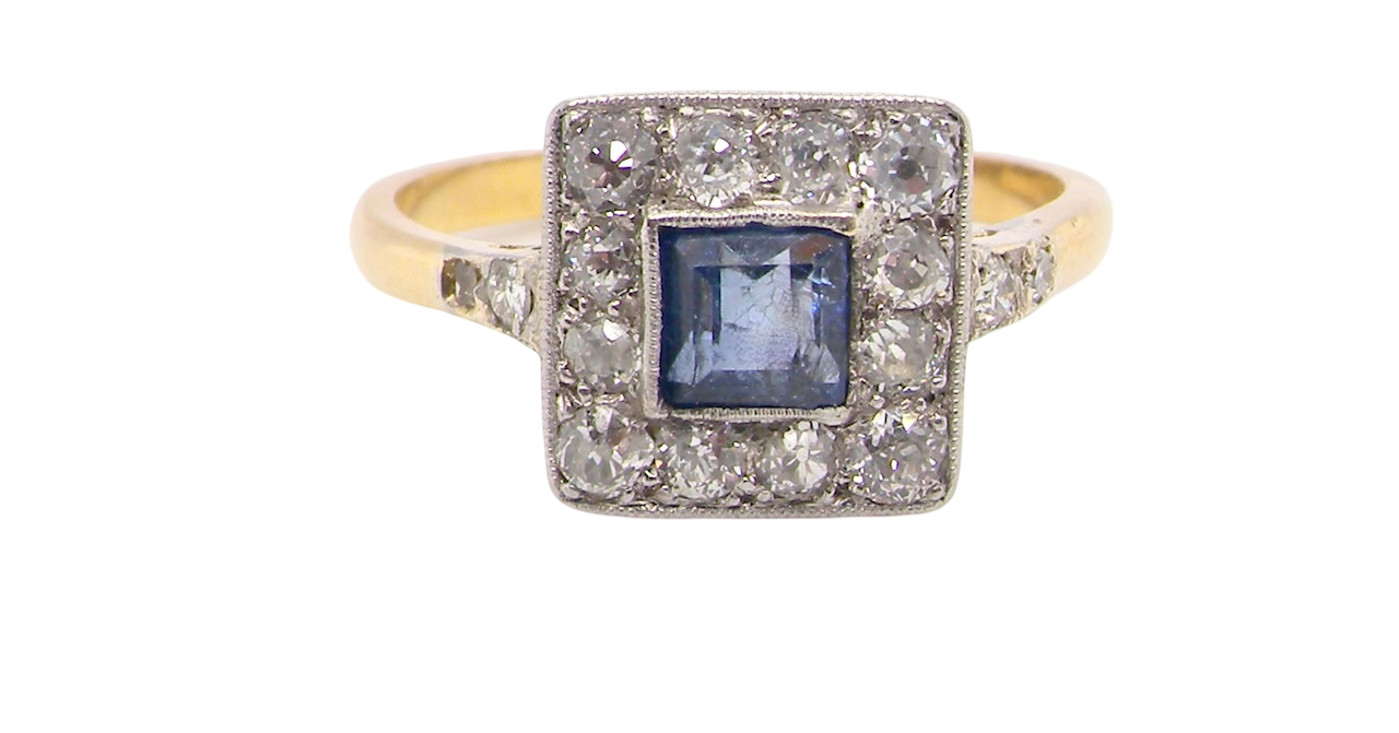 A fine Art Deco cluster ring. The centre stone a square sapphire 5x5mm in a mille grain setting.