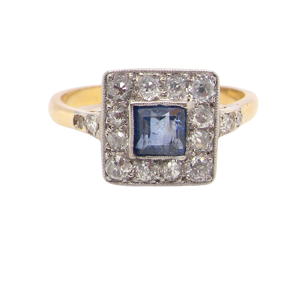 A fine Art Deco cluster ring. The centre stone a square sapphire 5x5mm in a mille grain setting.