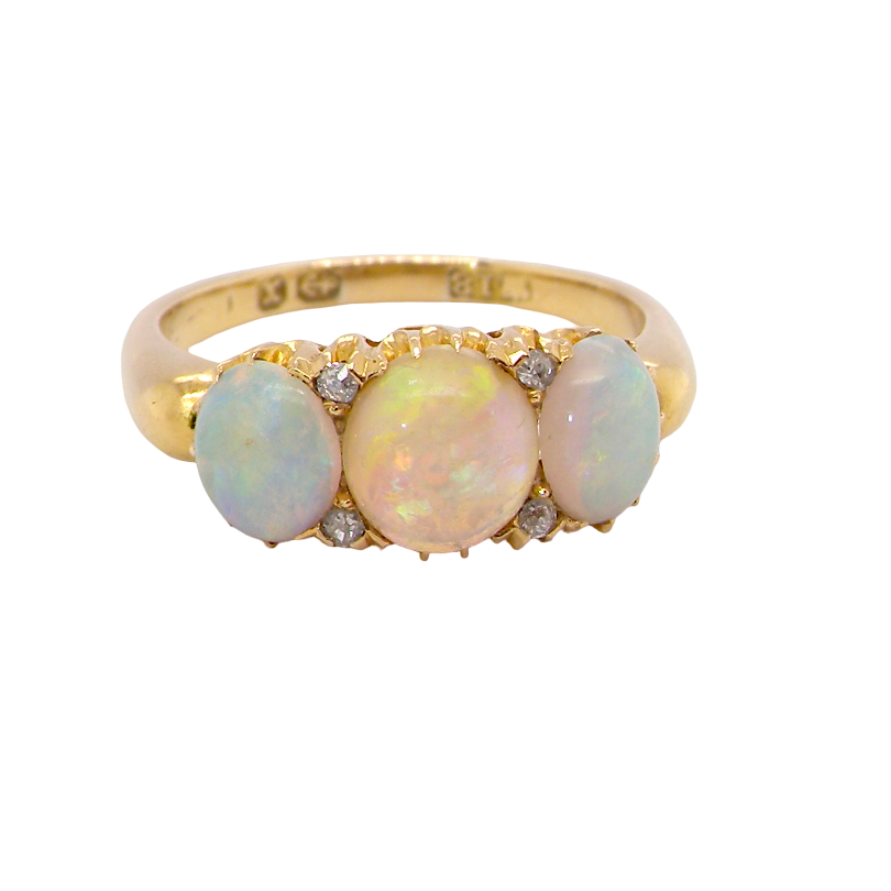 A yellow gold ring featuring three oval opal gemstones in a row, with small clear accent stones on either side of the center stone, shown against a plain white background.